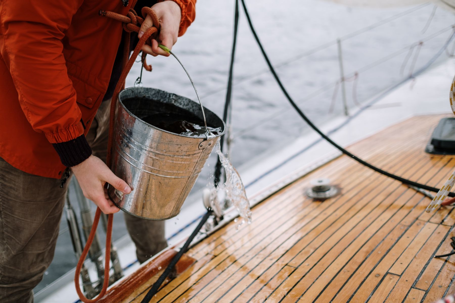 A boat deck being washed by hand